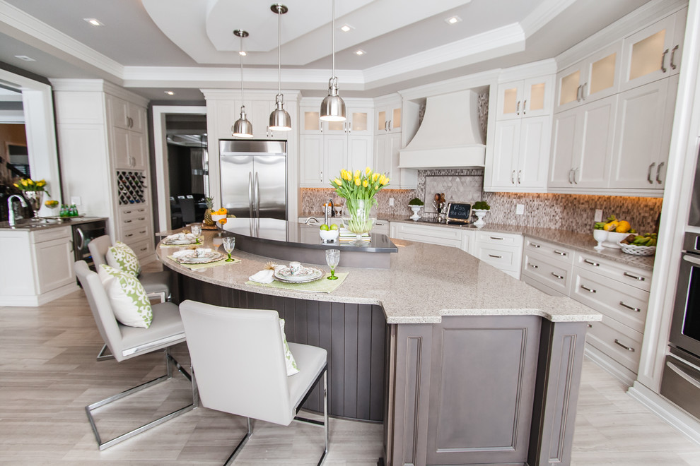 Photo of a large transitional single-wall eat-in kitchen in Toronto with raised-panel cabinets, white cabinets and with island.