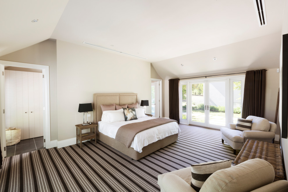 This is an example of a large contemporary guest bedroom in Melbourne with carpet and vaulted.