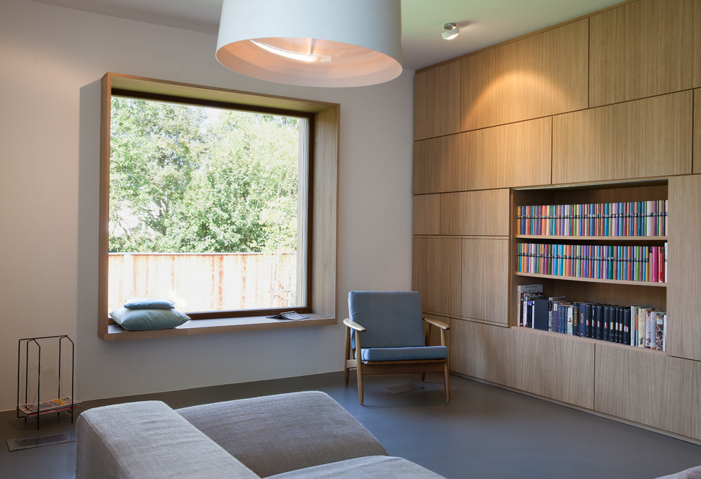 Photo of a mid-sized enclosed living room in Other with a library, white walls and linoleum floors.