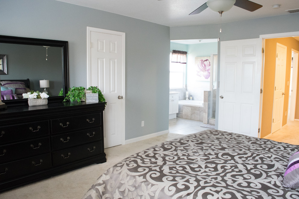 Photo of a mid-sized transitional master bedroom in Sacramento with blue walls, carpet, no fireplace and beige floor.