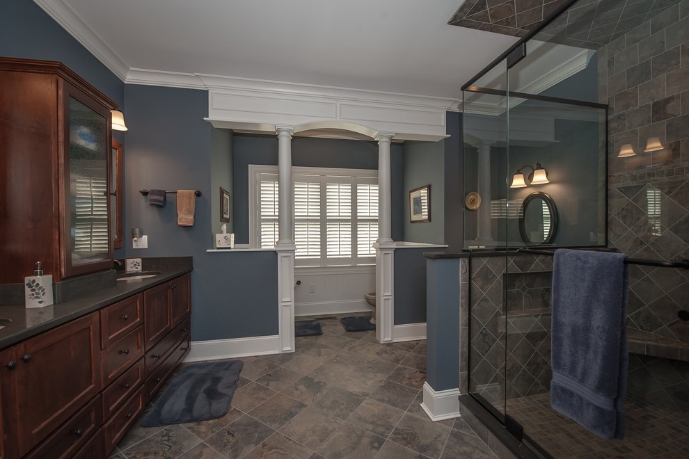 This is an example of a large traditional master bathroom in Boston with recessed-panel cabinets, brown cabinets, a bidet, blue tile, ceramic tile, blue walls, ceramic floors and engineered quartz benchtops.