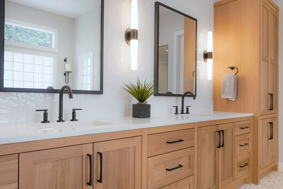 Photo of a large transitional master wet room bathroom in Denver with shaker cabinets, light wood cabinets, a freestanding tub, white tile, subway tile, an undermount sink, a hinged shower door, white benchtops, a double vanity and a built-in vanity.