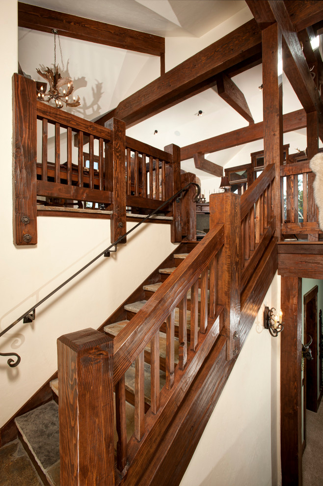 Inspiration for a country slate u-shaped staircase in Denver with wood risers and wood railing.