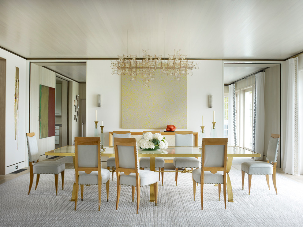 Photo of a contemporary dining room in New York with white walls and carpet.