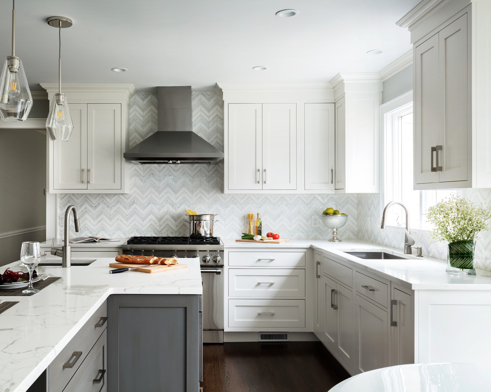 Small transitional u-shaped dark wood floor and brown floor eat-in kitchen photo in New York with an undermount sink, white backsplash, mosaic tile backsplash, stainless steel appliances, an island, white countertops, shaker cabinets and gray cabinets