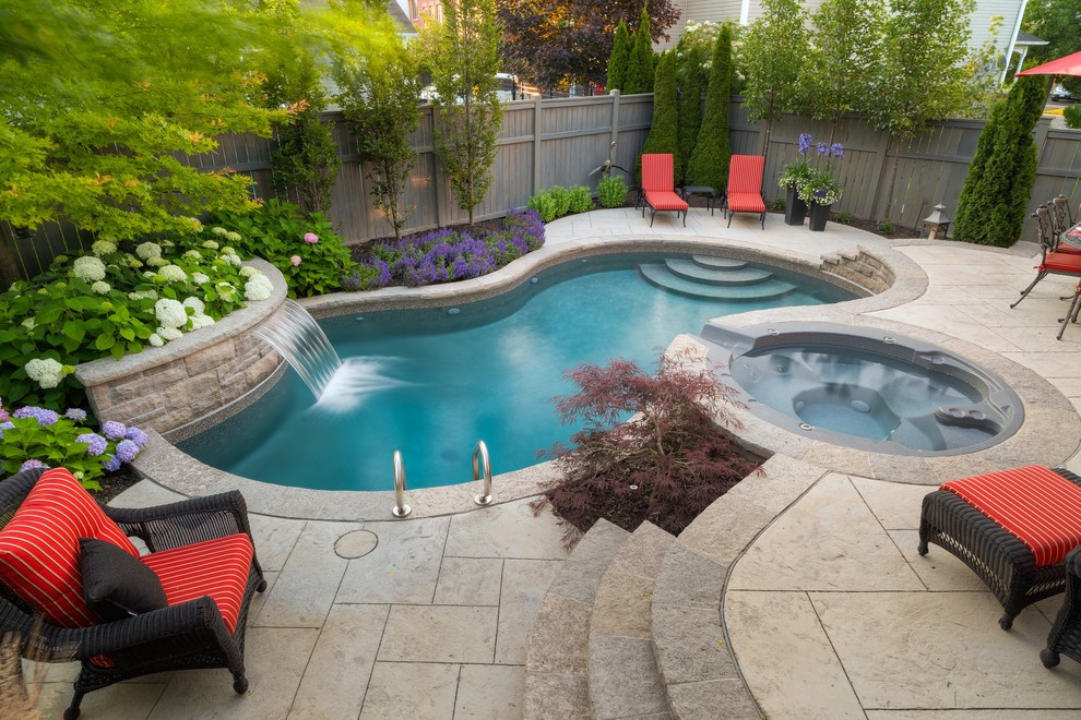 Inspiration for a small contemporary backyard custom-shaped pool in Toronto with a water feature and stamped concrete.
