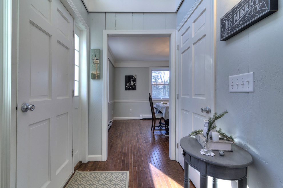 Photo of a small country front door in Boston with grey walls, dark hardwood floors, a single front door and a white front door.