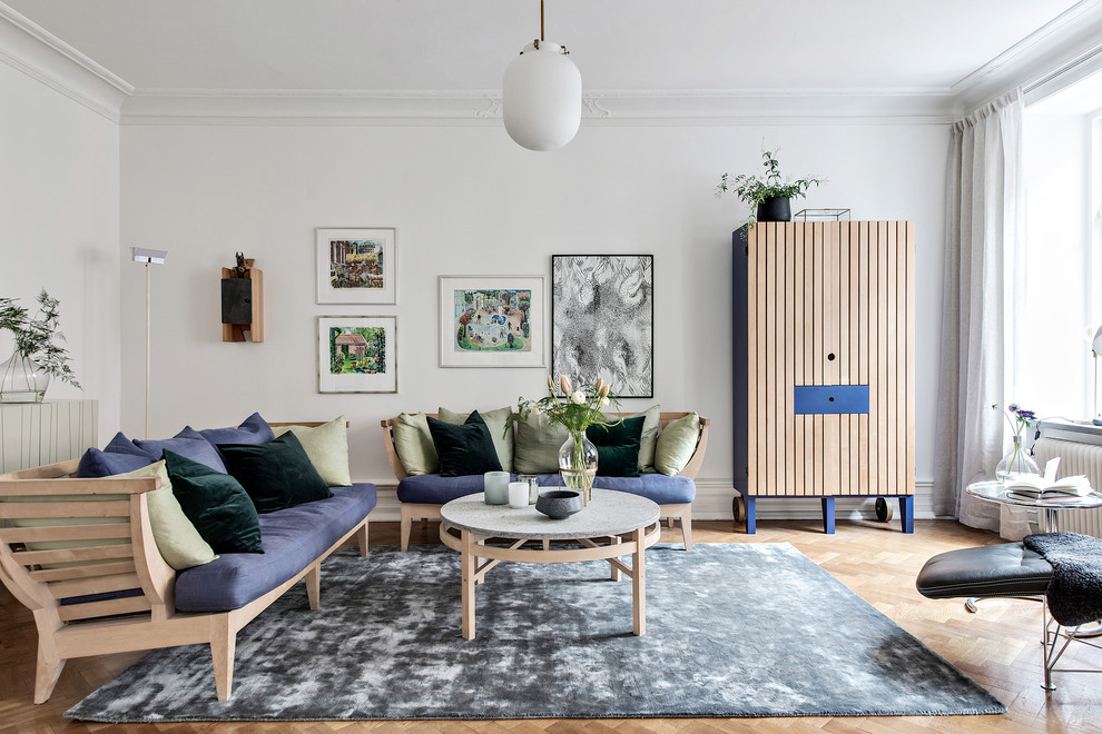 Photo of a large scandinavian formal enclosed living room in Gothenburg with white walls, light hardwood floors and beige floor.