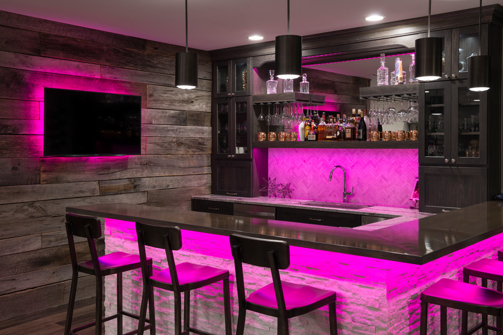 This is an example of a large contemporary home bar in Indianapolis with laminate floors.