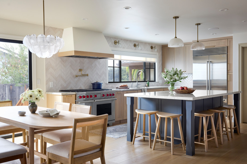 Huge transitional light wood floor and beige floor eat-in kitchen photo in Other with an undermount sink, shaker cabinets, light wood cabinets, quartz countertops, multicolored backsplash, ceramic backsplash, stainless steel appliances, an island and white countertops
