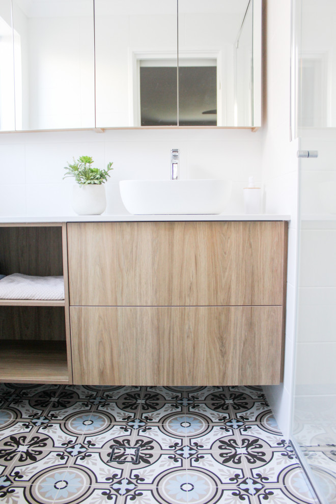 Photo of a mid-sized midcentury master bathroom in Perth with open cabinets, dark wood cabinets, an alcove shower, a one-piece toilet, white tile, ceramic tile, white walls, porcelain floors, a vessel sink, engineered quartz benchtops, blue floor, a hinged shower door, white benchtops, a niche, a single vanity and a floating vanity.