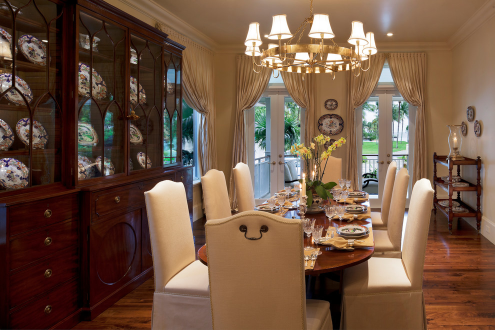 This is an example of a large traditional separate dining room in Miami with beige walls, dark hardwood floors, no fireplace and brown floor.