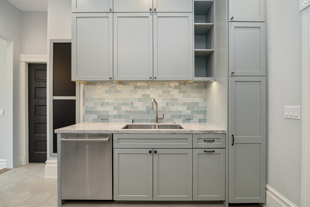 Inspiration for a large traditional l-shaped eat-in kitchen in San Francisco with a double-bowl sink, recessed-panel cabinets, grey cabinets, granite benchtops, green splashback, glass tile splashback, stainless steel appliances, ceramic floors, with island, beige floor, grey benchtop and coffered.