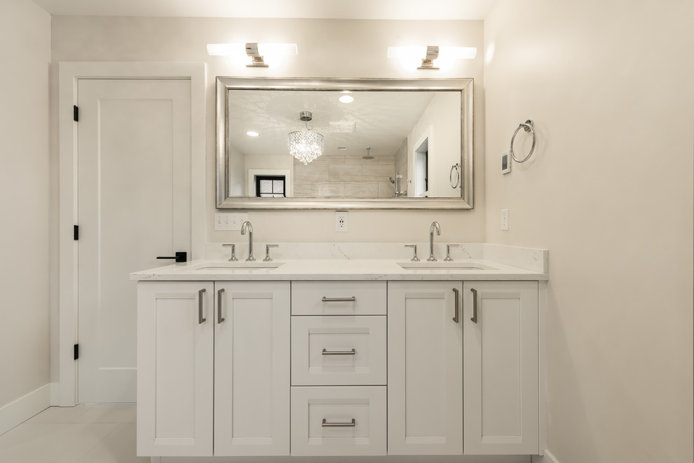 This is an example of a large transitional master bathroom in Seattle with recessed-panel cabinets, white cabinets, a corner shower, a one-piece toilet, beige tile, porcelain tile, beige walls, porcelain floors, an undermount sink, quartzite benchtops, beige floor and an open shower.