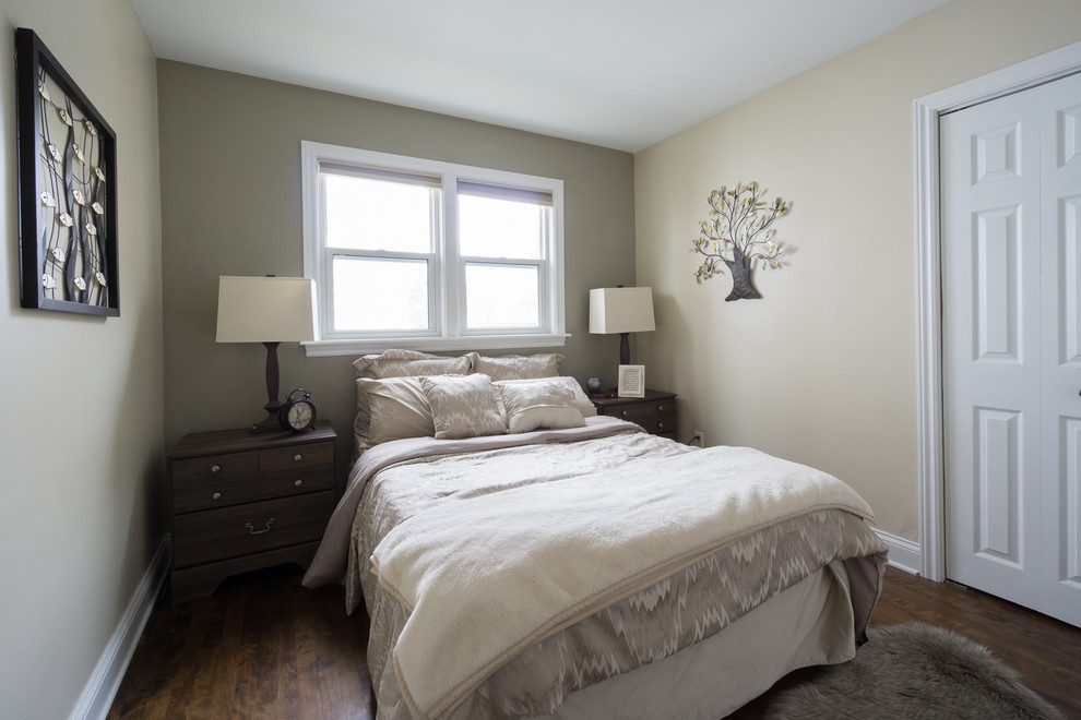 This is an example of a small transitional guest bedroom in Other with beige walls, dark hardwood floors and no fireplace.