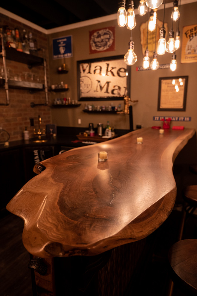 This is an example of a large traditional u-shaped home bar in Detroit with wood benchtops.