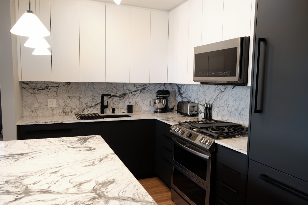 Photo of a small contemporary l-shaped kitchen/diner in Vancouver with a submerged sink, flat-panel cabinets, black cabinets, engineered stone countertops, engineered quartz splashback, integrated appliances, an island and white worktops.