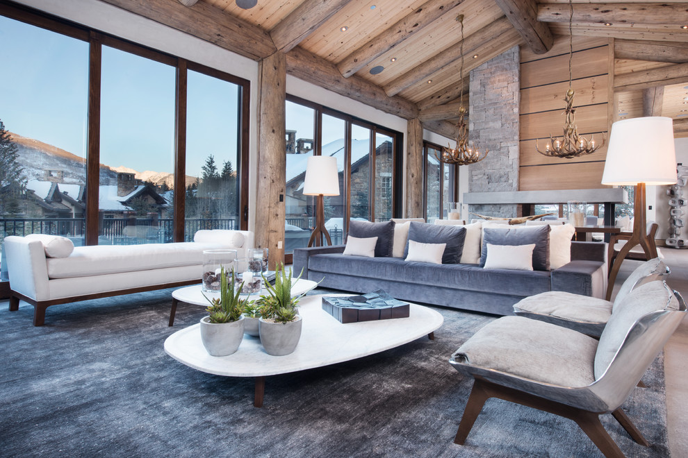 Vail Ski Haus - Living room - large contemporary formal and open concept living room idea in Denver with beige walls, a two-sided fireplace and a stone fireplace