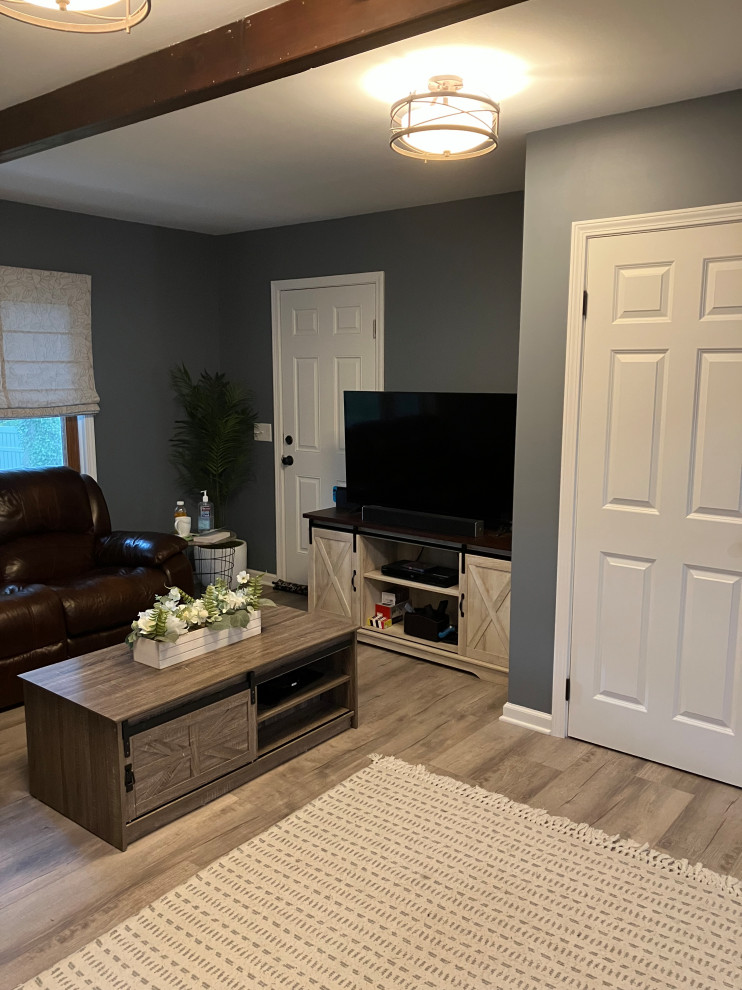 Cette image montre un petit salon traditionnel fermé avec un mur gris, un sol en vinyl, une cheminée standard, un manteau de cheminée en lambris de bois, un téléviseur indépendant, un sol gris et un plafond à caissons.
