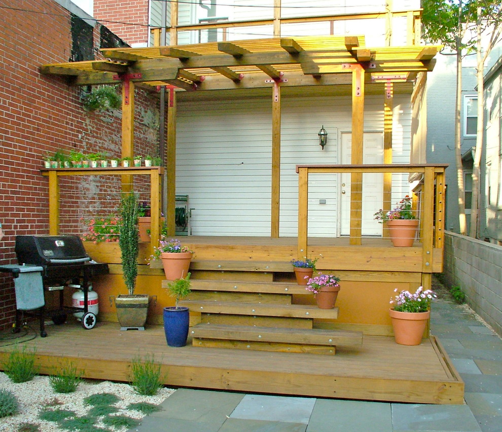 Contemporary backyard deck in Baltimore with a pergola.