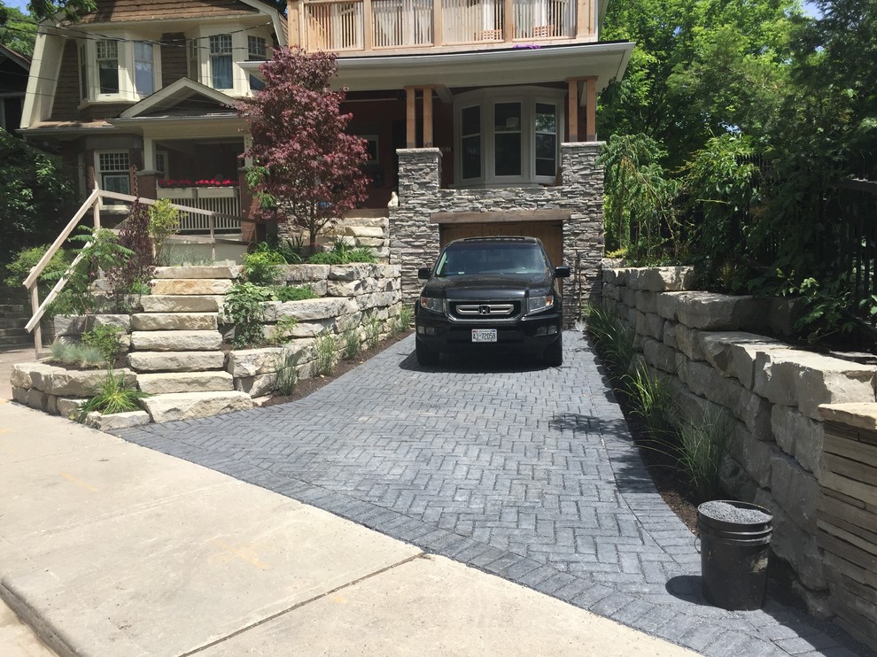Inspiration for a mid-sized rustic partial sun front yard stone driveway in Orange County for summer.