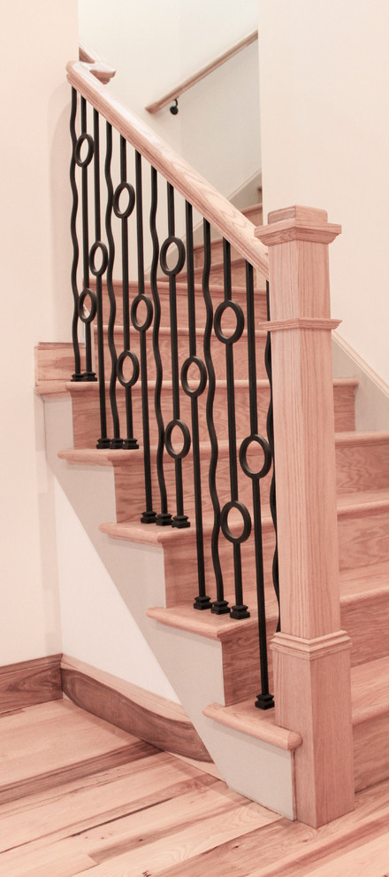 This is an example of a mid-sized country wood straight staircase in DC Metro with wood risers and mixed railing.