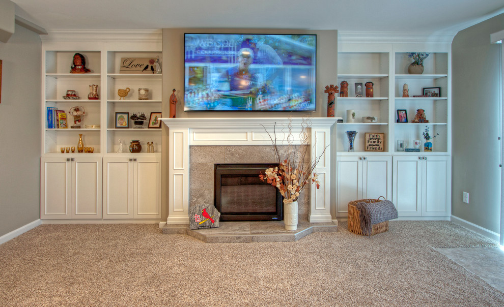 Design ideas for a mid-sized transitional walk-out basement in St Louis with beige walls, carpet and a standard fireplace.