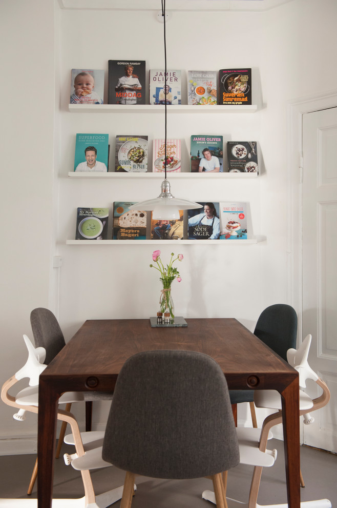Example of a danish gray floor kitchen/dining room combo design in Los Angeles with white walls