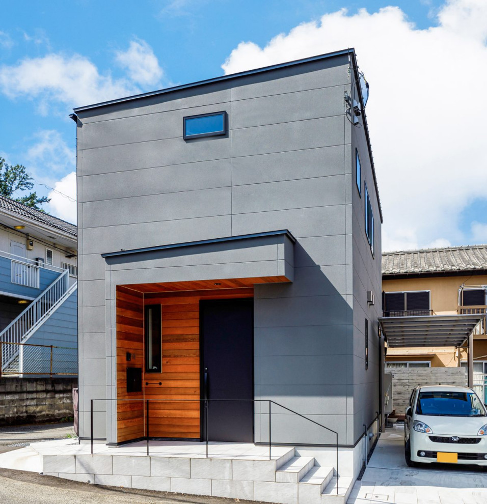Photo of a mid-sized industrial two-storey grey house exterior in Tokyo Suburbs with mixed siding, a shed roof, a metal roof and a grey roof.