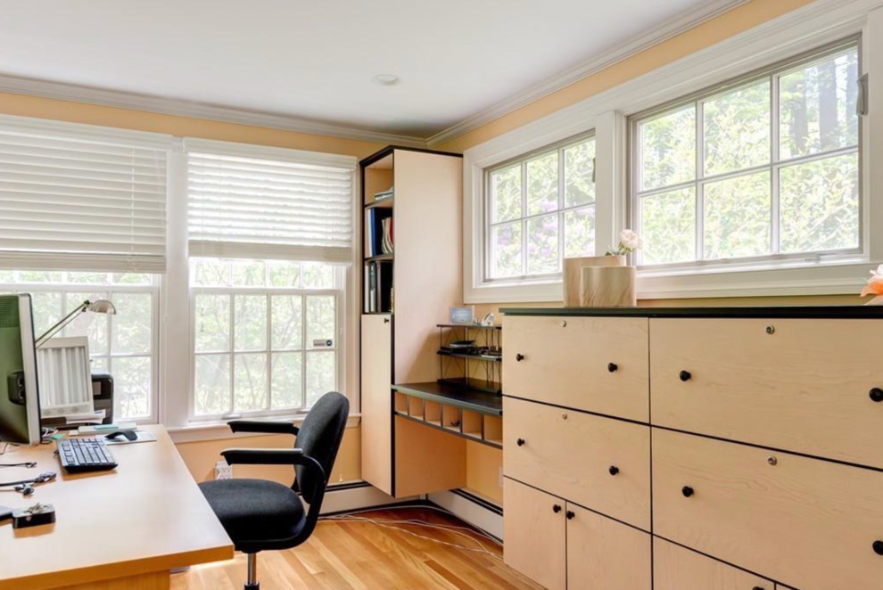 Design ideas for a mid-sized traditional home studio in Boston with yellow walls, medium hardwood floors and a freestanding desk.