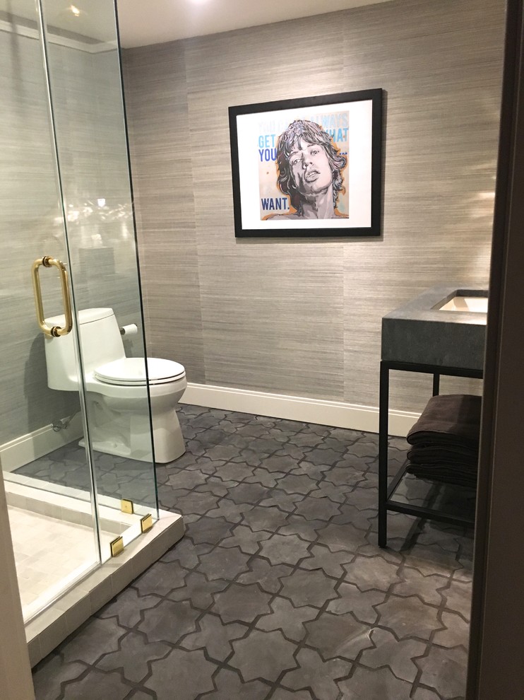 Photo of a small contemporary bathroom in DC Metro with a corner shower, a one-piece toilet, grey walls, terra-cotta floors, a drop-in sink, marble benchtops, black floor and a hinged shower door.