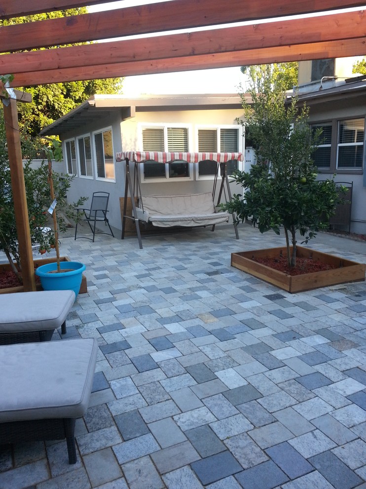 Inspiration for a timeless backyard stone patio remodel in Phoenix
