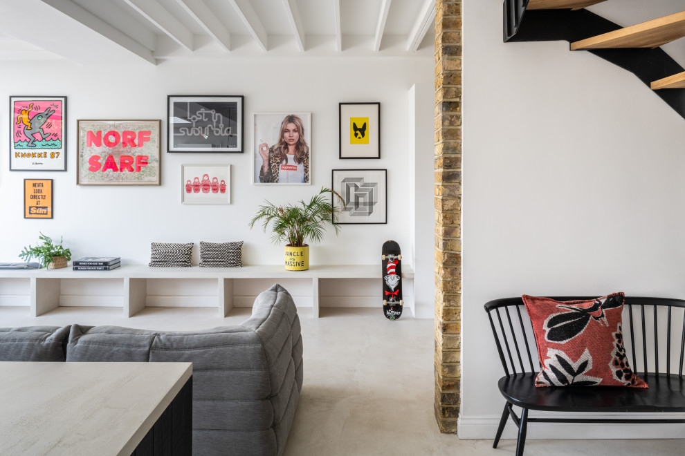 Photo of a contemporary living room in London with white walls, concrete flooring and grey floors.