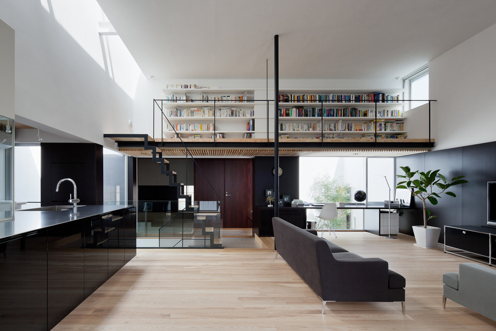 Photo of a contemporary living room in Tokyo with white walls, light hardwood floors and beige floor.