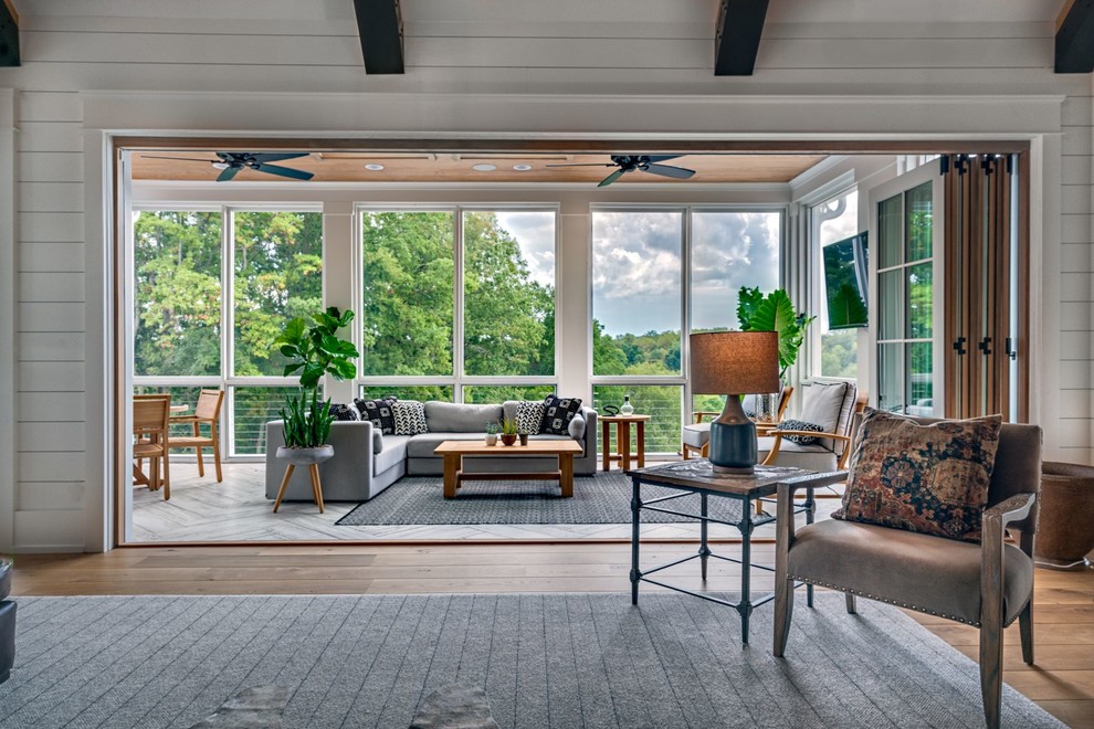 Mid-sized country sunroom in Nashville with medium hardwood floors, no fireplace, a standard ceiling and brown floor.