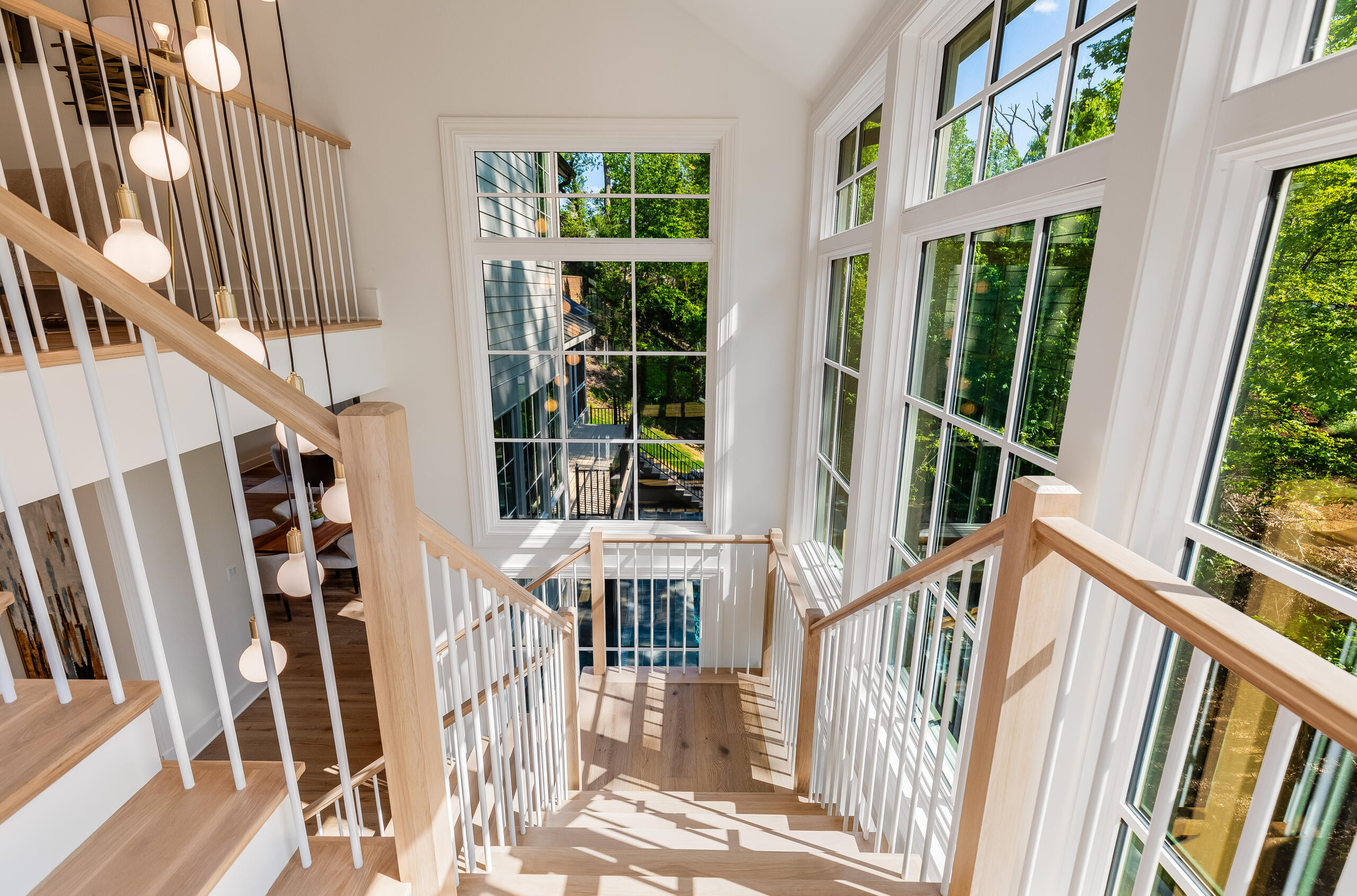 Project #152 | Three-Story White Oak Staircase with a Pendant Chandelier
