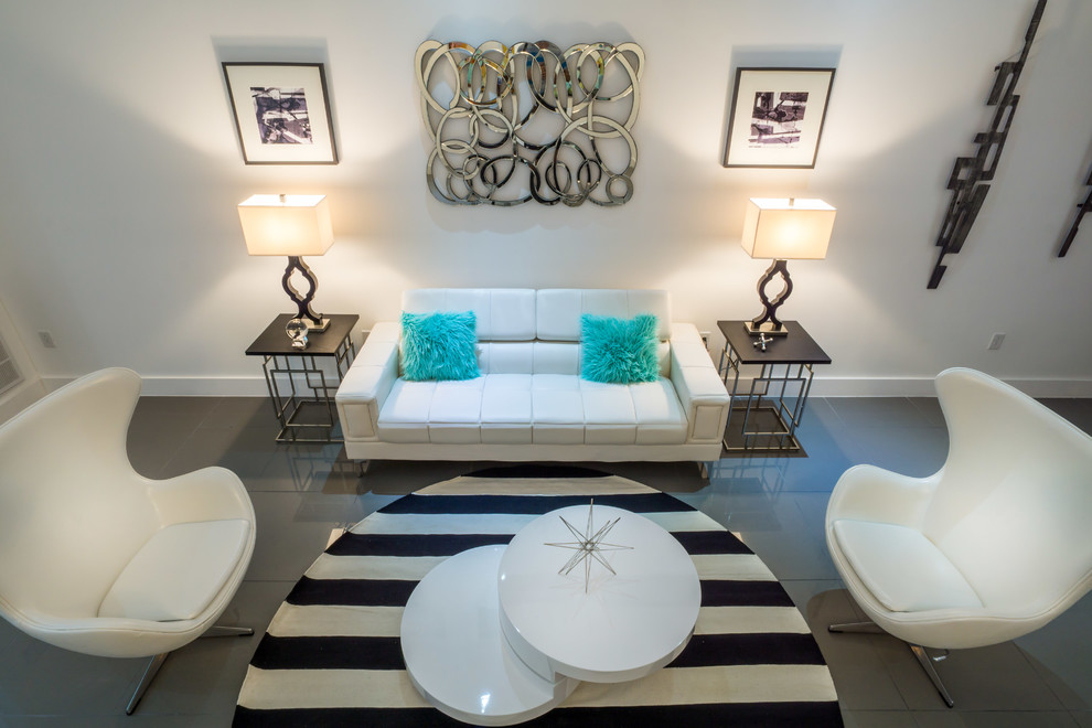 This is an example of a modern living room in Orlando with white walls and porcelain floors.