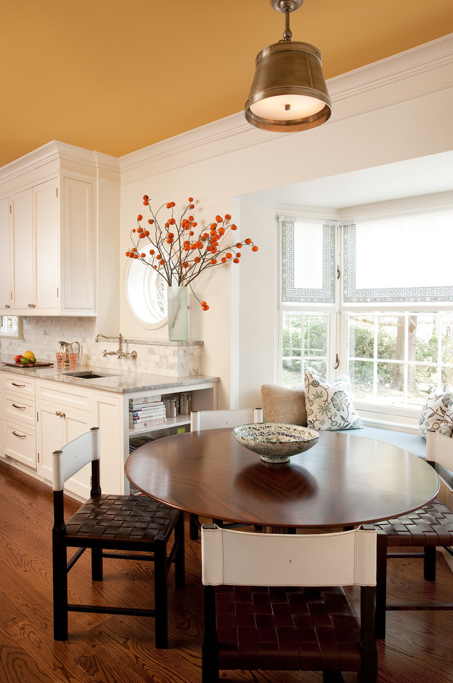 Elegant medium tone wood floor eat-in kitchen photo in Bridgeport with shaker cabinets, white cabinets and white walls