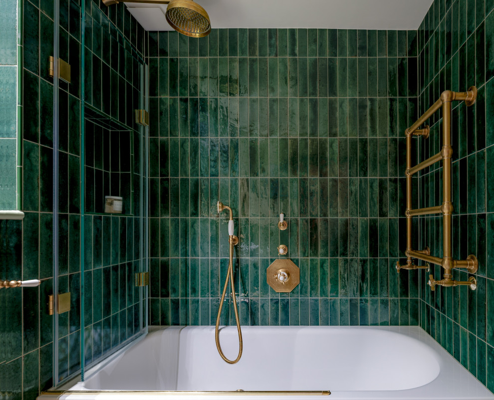 Photo of a mid-sized traditional kids bathroom in London with an alcove tub, a shower/bathtub combo, a wall-mount toilet, green tile, ceramic tile, a wall-mount sink, a single vanity, white walls, porcelain floors, grey floor and panelled walls.
