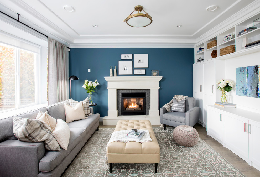 This is an example of a medium sized victorian open plan living room in Vancouver with a reading nook, a standard fireplace and a concrete fireplace surround.