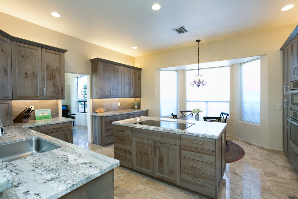 Small mountain style l-shaped ceramic tile eat-in kitchen photo in Phoenix with an undermount sink, flat-panel cabinets, gray cabinets, granite countertops, gray backsplash, ceramic backsplash, stainless steel appliances and an island