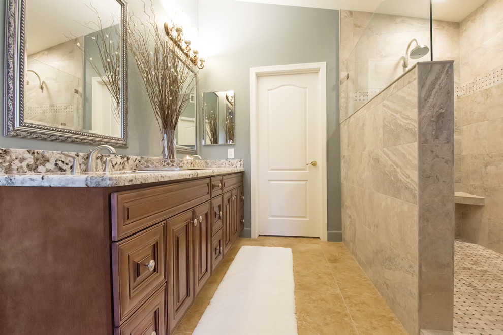 This is an example of a mid-sized traditional master bathroom in Phoenix with raised-panel cabinets, brown cabinets, an open shower, beige tile, porcelain tile, beige walls, an undermount sink, granite benchtops and an open shower.