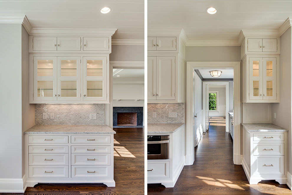 Eat-in kitchen - mid-sized transitional l-shaped dark wood floor and brown floor eat-in kitchen idea with an undermount sink, recessed-panel cabinets, white cabinets, white backsplash, stainless steel appliances, an island and marble countertops