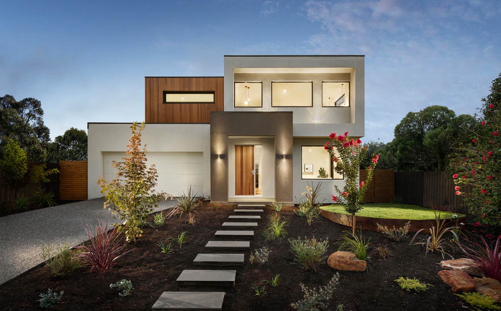 This is an example of a contemporary two-storey white house exterior in Melbourne with a flat roof.