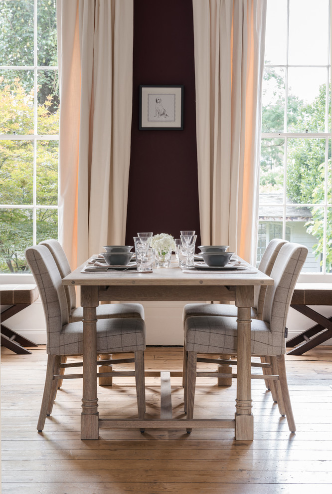 Design ideas for a country dining room in London with white walls, light hardwood floors and no fireplace.