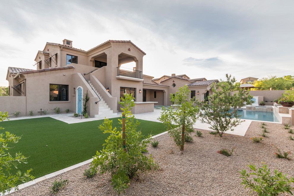 Huge transitional beige two-story stucco house exterior photo in Phoenix with a tile roof