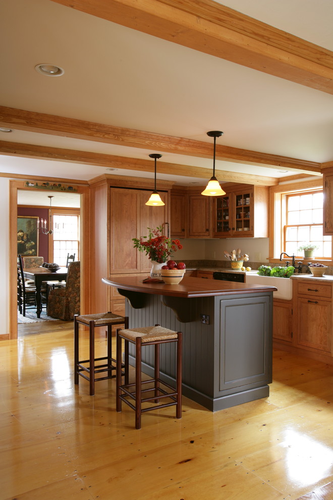 Photo of a mid-sized arts and crafts separate kitchen in Boston with a farmhouse sink, wood benchtops, light wood cabinets, panelled appliances, light hardwood floors, with island, beige floor and brown benchtop.