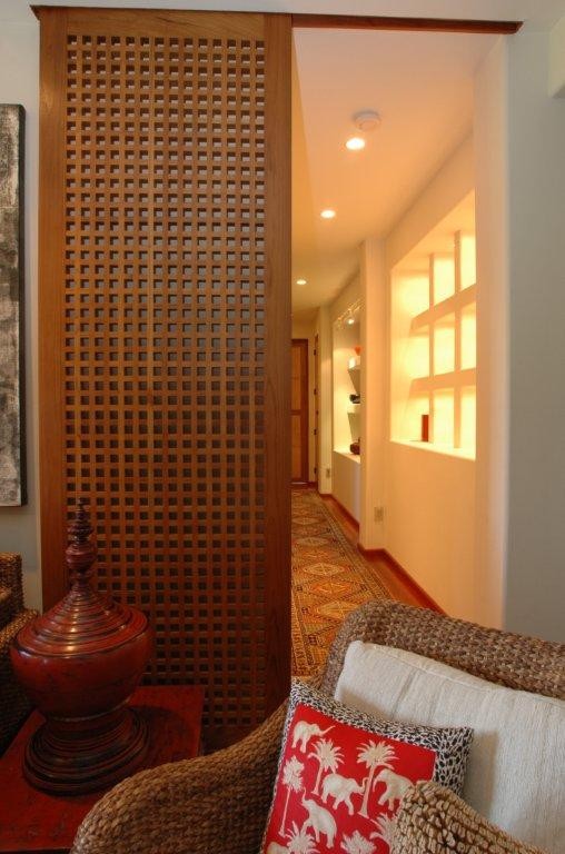 Photo of a large asian hallway in San Diego with white walls, medium hardwood floors and brown floor.