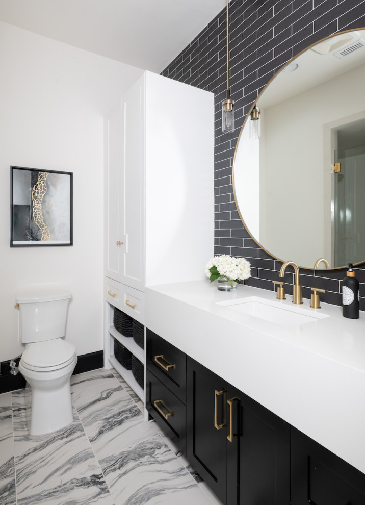 This is an example of a mid-sized scandinavian powder room in Dallas with beaded inset cabinets, black cabinets, a two-piece toilet, black tile, ceramic tile, white walls, marble floors, an undermount sink, engineered quartz benchtops, white floor and white benchtops.