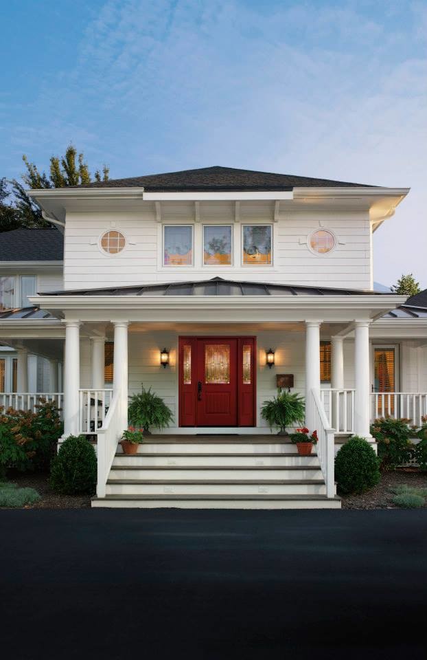 Photo of a large traditional entryway in Raleigh with white walls, a single front door and a red front door.
